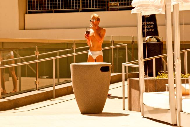West Hollywood makes a splash in Las Vegas as The Abbey Beach debuts at Vdara Hotel and Spa.  A customer enjoys a cigarette at Vdara's Abbey Beach on Sunday, August 29.  Vdaras chic Pool & Lounge is decked out with The Abbeys colorful flags and beach balls, while its 19 fully appointed cabanas are serviced by the handsome Abbey Boys.  Widely known as one of the most popular West Hollywood hot spots, The Abbey Food & Bar has partnered with Las Vegas party planner Eduardo Cordova and Vdara Hotel & Spa to host The Abbey Beach.  The Abbey Beach at Vdara Pool & Lounge occurs every Sunday now through September 26, noon  6 p.m offering a taste of The Abbeys signature LGBT party in the heart of CityCenter.